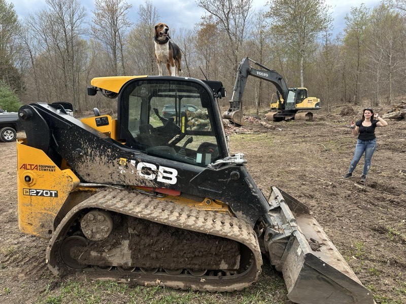 Excavation contractor operating CAT excavator on commercial site in Oswego County NY