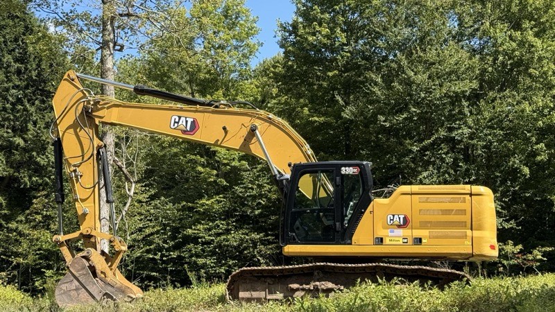 Komatsu excavator digging utility trench for water main replacement