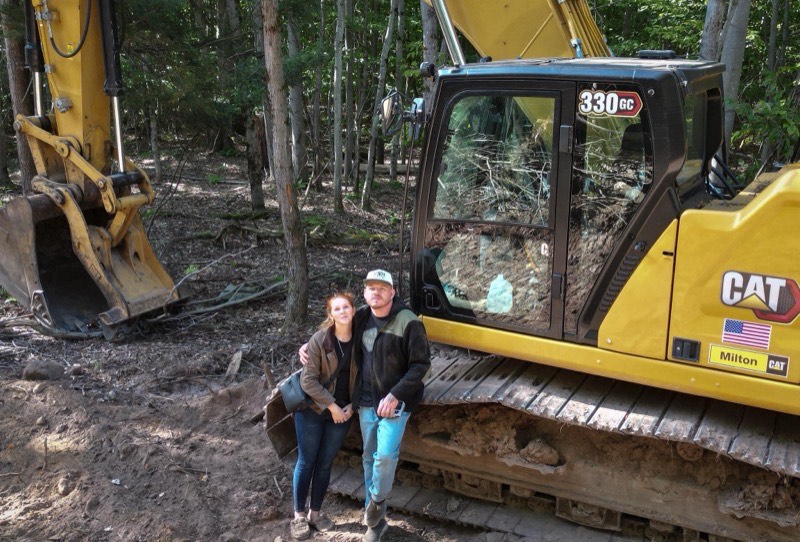 Heavy excavator performing rock removal during commercial site excavation