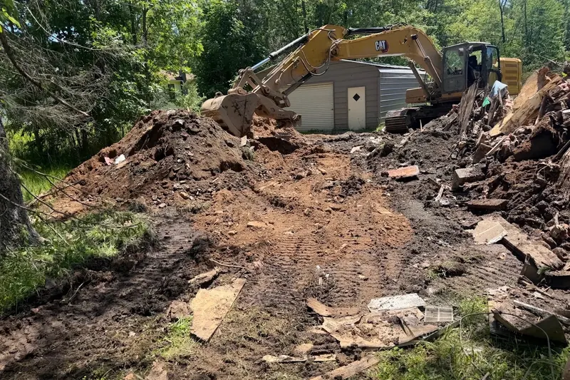 Excavator removing the foundation after a house was taken down