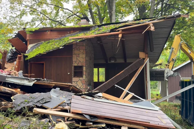 Roof of a wood-frame house collapsing during a teardown