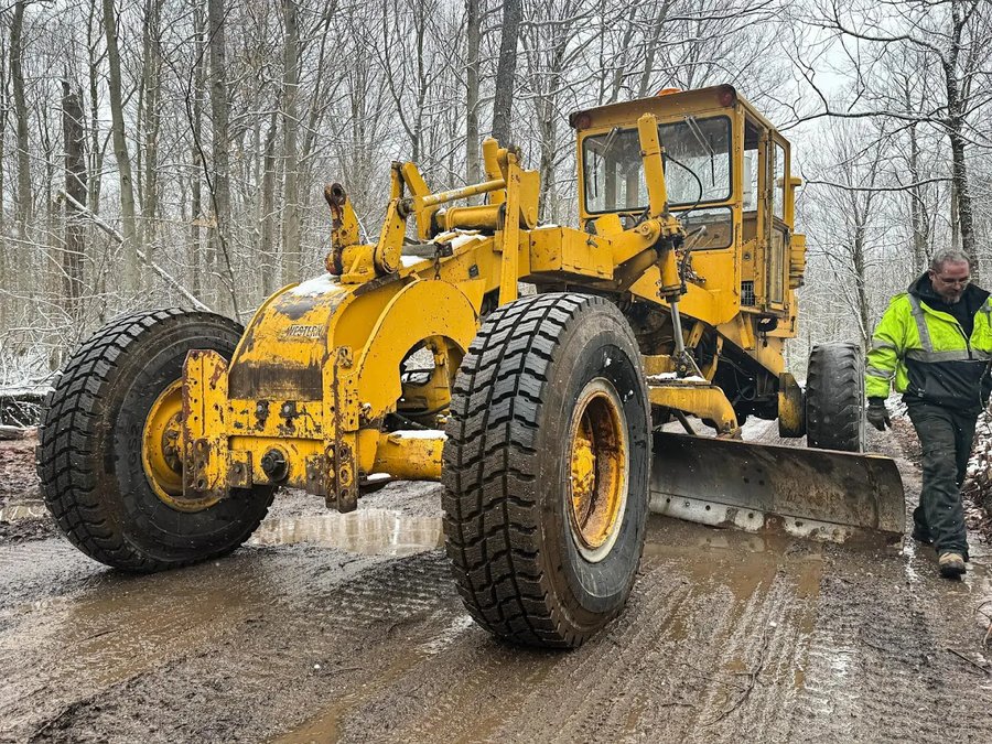 Motor grader finishing subgrade on a commercial pad